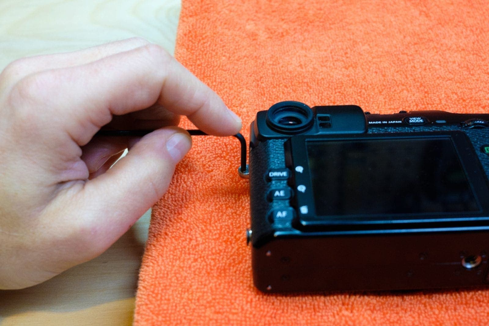 Pushing out the Fuji strap lug inserts to install string disconnect like Optech or Peak Design