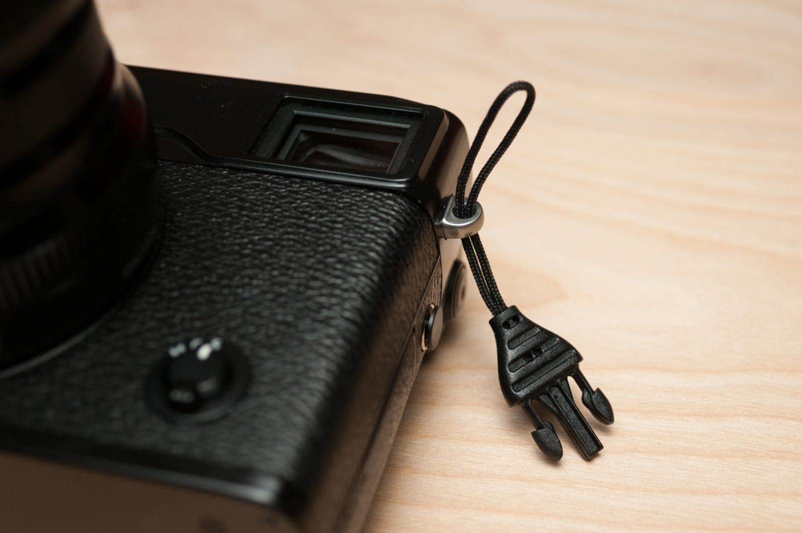 Thread the cord loop through the strap lug. It might help to use a piece of string or dental floss.